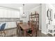 Dining area featuring a large wooden table with seating for six, modern lighting, and stylish decor at 10814 Matherly Way, Noblesville, IN 46060