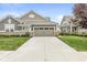 A single-Gathering home with attached two-car garage and concrete driveway lined with green grass at 10814 Matherly Way, Noblesville, IN 46060