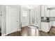 Bright entryway with wood flooring, a glass-paneled door, and neutral decor for a welcoming first impression at 10814 Matherly Way, Noblesville, IN 46060