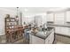 Bright kitchen with dark countertops, stainless sink, wood floors, and dining area at 10814 Matherly Way, Noblesville, IN 46060