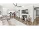 Spacious living room showcasing fireplace, television, and seamless flow into a modern kitchen at 10814 Matherly Way, Noblesville, IN 46060