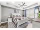 Main bedroom features a ceiling fan, window, king bed, side tables, and carpet at 10814 Matherly Way, Noblesville, IN 46060