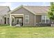 Exterior view featuring a covered patio, well-maintained backyard, and neutral siding at 10814 Matherly Way, Noblesville, IN 46060