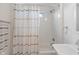 Bright white bathroom featuring a shower/tub combination with stylish curtain and vanity at 11315 House St, Indianapolis, IN 46259