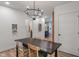 This dining room features a modern chandelier, a dining table and hardwood floors at 11315 House St, Indianapolis, IN 46259