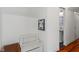 Bright hallway with a white storage bench, whimsical artwork, and access to a bathroom at 11315 House St, Indianapolis, IN 46259