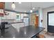 Well-lit kitchen featuring white cabinets, stainless steel appliances, and a dark countertop island at 11315 House St, Indianapolis, IN 46259