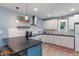 Bright kitchen featuring white cabinets, subway tile backsplash, and a black countertop island at 11315 House St, Indianapolis, IN 46259
