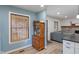 Kitchen with a window, wooden hutch, wood floors, and views of the living room at 11315 House St, Indianapolis, IN 46259