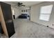 Spacious bedroom with neutral carpet, ceiling fan, and decorative wall art above the bed at 12536 Teacup Ne Way, Indianapolis, IN 46235