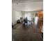 Dining room with hardwood floors, modern chandelier, and view into the kitchen at 12536 Teacup Ne Way, Indianapolis, IN 46235
