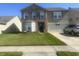 Two-story home featuring a brick facade, well-maintained lawn, and an attached two-car garage at 12536 Teacup Ne Way, Indianapolis, IN 46235