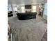 Open-concept living room with gray carpet, fireplace, and adjacent to the kitchen and dining area at 12536 Teacup Ne Way, Indianapolis, IN 46235