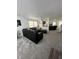 Spacious living room with gray carpet, a contemporary light, and an open floor plan at 12536 Teacup Ne Way, Indianapolis, IN 46235