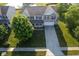 A beautiful aerial shot showcases a well-maintained two-story home with lush landscaping and a spacious driveway at 12847 Arvada Pl, Fishers, IN 46038