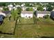 Aerial view of a home's fenced backyard featuring a patio, play set, and expansive lawn at 12847 Arvada Pl, Fishers, IN 46038