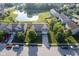 Scenic aerial shot of a neighborhood, with well-kept homes situated near a tranquil pond and lush trees at 12847 Arvada Pl, Fishers, IN 46038