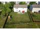 Aerial view of a home's fenced backyard featuring a patio, play set, and expansive lawn at 12847 Arvada Pl, Fishers, IN 46038