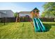 Backyard featuring a wooden playset with slides, swings, and a climbing structure at 12847 Arvada Pl, Fishers, IN 46038