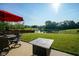 Backyard featuring a patio with a table and chairs, fire pit, and pond view at 12847 Arvada Pl, Fishers, IN 46038