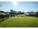 Large backyard with a pond view, black fencing, and lush green grass at 12847 Arvada Pl, Fishers, IN 46038