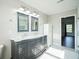 Bathroom features a double vanity with mirrors, granite countertop and tile flooring at 12847 Arvada Pl, Fishers, IN 46038