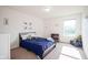 Bright bedroom featuring a bed with blue bedding, dinosaur decor, and a cozy reading nook at 12847 Arvada Pl, Fishers, IN 46038