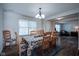 Bright dining room with wood floors, a patterned rug, a table with seating for six, and a window at 12847 Arvada Pl, Fishers, IN 46038