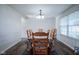Traditional dining room featuring a wooden table with seating for six, a chandelier, and natural light at 12847 Arvada Pl, Fishers, IN 46038