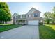 Charming two-story home with well-manicured lawn and inviting front porch at 12847 Arvada Pl, Fishers, IN 46038