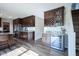 Beautiful kitchen with dark wood cabinets, stainless steel appliances, granite counters and a wine fridge at 12847 Arvada Pl, Fishers, IN 46038