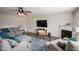 Comfortable living room with a ceiling fan, a fireplace, and a plush sofa with throw pillows at 12847 Arvada Pl, Fishers, IN 46038