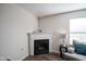 Cozy living room corner featuring a fireplace, a comfortable chair, and a stylish lamp at 12847 Arvada Pl, Fishers, IN 46038