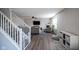 Inviting living room features modern furnishings, a fireplace, and a staircase with white railings at 12847 Arvada Pl, Fishers, IN 46038