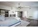 Large main bedroom with ceiling fan, ensuite bathroom, and access to other rooms at 12847 Arvada Pl, Fishers, IN 46038