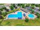 Aerial view of community swimming pool and lounge area with umbrellas, chairs and a clubhouse at 12997 Bartlett Dr, Fishers, IN 46037