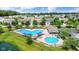 Aerial view of the community pool area with multiple swimming pools, lounge chairs and umbrellas at 12997 Bartlett Dr, Fishers, IN 46037