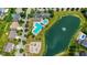 Aerial view of a community with a pond, playground and swimming pool for Gathering fun and relaxation at 12997 Bartlett Dr, Fishers, IN 46037