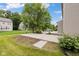 Backyard featuring a concrete patio, basketball hoop, and mature tree at 12997 Bartlett Dr, Fishers, IN 46037