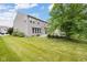 Spacious backyard featuring a lush lawn and partial view of house at 12997 Bartlett Dr, Fishers, IN 46037
