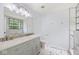 Bright bathroom with a large mirror, double vanity, and a walk-in shower at 12997 Bartlett Dr, Fishers, IN 46037
