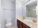 Bright bathroom with double sinks, cherry cabinets, and a shower/tub combo at 12997 Bartlett Dr, Fishers, IN 46037