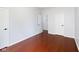 Simple bedroom with white walls, hardwood floors, and two doors at 12997 Bartlett Dr, Fishers, IN 46037