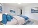 A staged bedroom features wall art, a large bed, and two doors at 12997 Bartlett Dr, Fishers, IN 46037