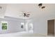 Spacious bedroom with ample natural light from large windows, a ceiling fan, and an attached closet at 12997 Bartlett Dr, Fishers, IN 46037