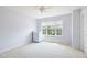A bedroom features a window, white walls, and a ceiling fan at 12997 Bartlett Dr, Fishers, IN 46037