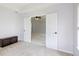 Carpeted room featuring a display cabinet, and an open door into another brightly lit carpeted room at 12997 Bartlett Dr, Fishers, IN 46037