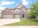 Charming brick home with a three-car garage and lush green lawn at 12997 Bartlett Dr, Fishers, IN 46037