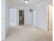 Hallway featuring plush carpet, multiple doorways, and convenient laundry access at 12997 Bartlett Dr, Fishers, IN 46037