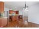 Open kitchen has stainless appliances, island, and wood cabinets with tile backsplash at 12997 Bartlett Dr, Fishers, IN 46037